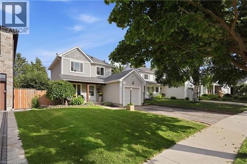 Two-story residence with light gray siding and shingle accents, featuring an attached single-car garage - 563 Westvale Drive, Waterloo, ON - Outdoor With Facade