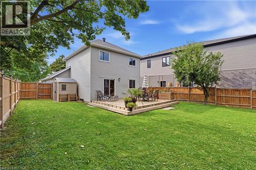 Spacious backyard featuring a wood deck, wood privacy fencing, and a storage shed - 563 Westvale Drive, Waterloo, ON - Outdoor With Deck Patio Veranda With Backyard With Exterior