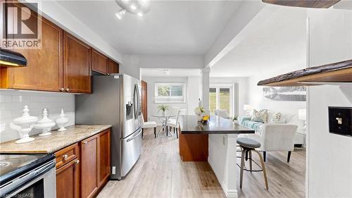 Kitchen featuring wood cabinetry, light-toned countertops, and a white subway tile backsplash - 304 Bluevale Street N, Waterloo, ON - Indoor Photo Showing Kitchen