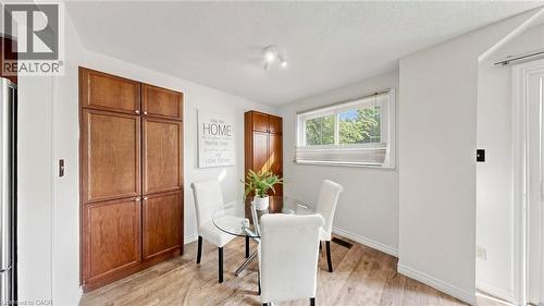 Hardwood-style flooring with built-in cabinetry and a window offering natural illumination - 304 Bluevale Street N, Waterloo, ON - Indoor Photo Showing Dining Room