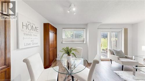 White walls with track lighting, wood-finish flooring, built-in cabinetry, and sliding glass doors to exterior - 304 Bluevale Street N, Waterloo, ON - Indoor Photo Showing Dining Room