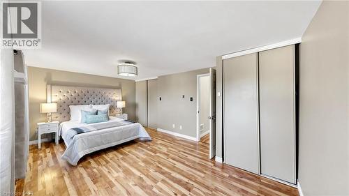 Wood-finish flooring, neutral wall tones, and recessed lighting - 304 Bluevale Street N, Waterloo, ON - Indoor Photo Showing Bedroom