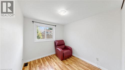 White walls with wood-finish flooring - 304 Bluevale Street N, Waterloo, ON - Indoor Photo Showing Other Room