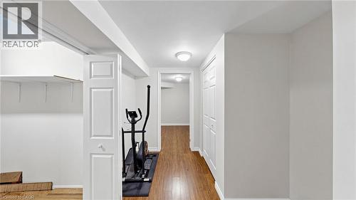Recessed storage area with shelving, paneled interior doors, and wood-finish flooring - 304 Bluevale Street N, Waterloo, ON - Indoor Photo Showing Other Room
