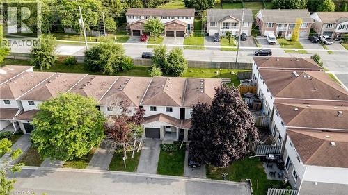 Townhome community with attached garages, paved driveways, and mature landscaping - 304 Bluevale Street N, Waterloo, ON - Outdoor With Facade