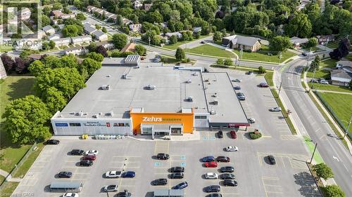Expansive commercial property featuring a large parking area, surrounding roadways, and visible retail storefronts - 304 Bluevale Street N, Waterloo, ON - Outdoor With View