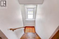 Hardwood staircase with a wood handrail - 