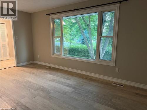 Expansive window with white trim, wood-finish flooring, and neutral wall tones - 70 Eagen Drive Unit# Upper Level, Kitchener, ON - Indoor Photo Showing Other Room