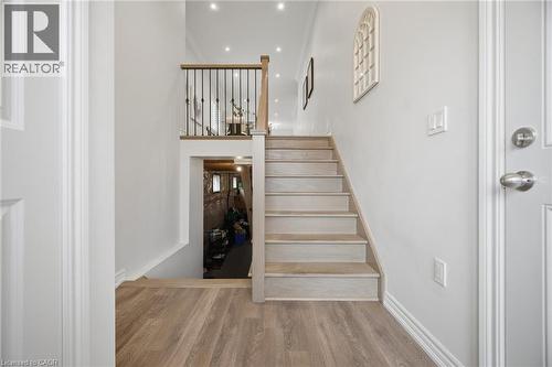 Wood-finish flooring leading to a staircase with wood treads - 20 Todd Crescent, Dundalk, ON - Indoor Photo Showing Other Room