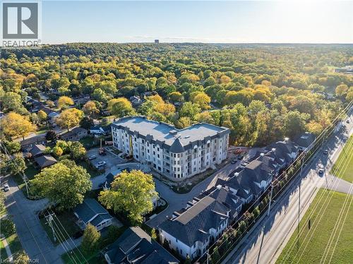 New construction multi-story building featuring a gray roof, light-toned exterior siding, and multiple balconies - 2 Arbourvale Common Unit# 209, St. Catharines, ON - Outdoor With View