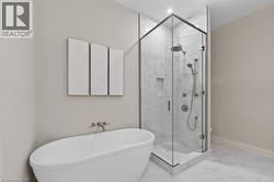Freestanding soaking tub with wall-mounted fixtures - 