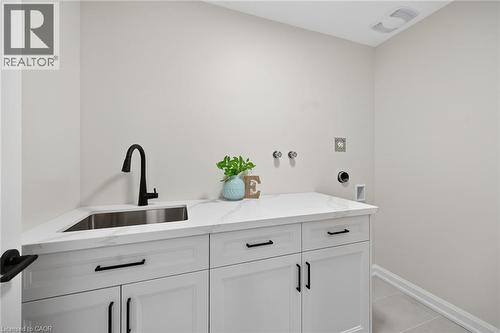 Convenient 2nd floor laundry room features modern cabinetry and quartz counter top. - 45B Howard Street, Hagersville, ON 