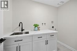 Convenient 2nd floor laundry room features modern cabinetry and quartz counter top. - 