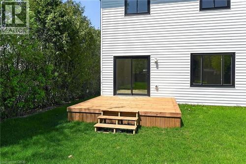 Exterior white horizontal siding with a wood deck featuring three steps - 45B Howard Street, Hagersville, ON 