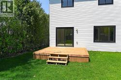 Exterior white horizontal siding with a wood deck featuring three steps - 