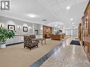 Panel accent walls, recessed lighting, wall sconces, wood paneling, and a tiled floor - 7 Gale Crescent Unit# 1107, St. Catharines, ON 