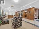 Carpeted flooring, recessed lighting, drop ceiling, elevator access, and wood paneling - 7 Gale Crescent Unit# 1107, St. Catharines, ON 