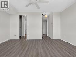 Wood-finish flooring, crown molding, ceiling fan, and recessed light fixture - 