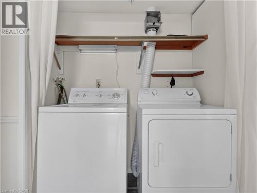 Dedicated laundry area featuring a white top-load washing machine and a white front-load dryer - 7 Gale Crescent Unit# 1107, St. Catharines, ON 