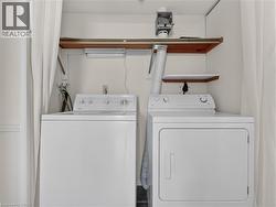 Dedicated laundry area featuring a white top-load washing machine and a white front-load dryer - 