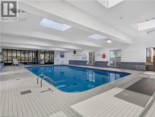 Indoor swimming pool with skylights, extensive tile surround, and glass panel doors - 7 Gale Crescent Unit# 1107, St. Catharines, ON 