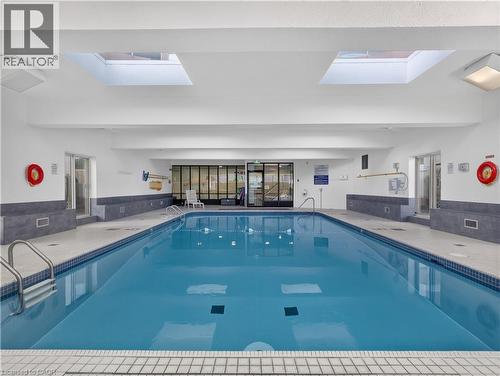 Indoor swimming pool with skylights, tile surround, and direct access to changing rooms - 7 Gale Crescent Unit# 1107, St. Catharines, ON 