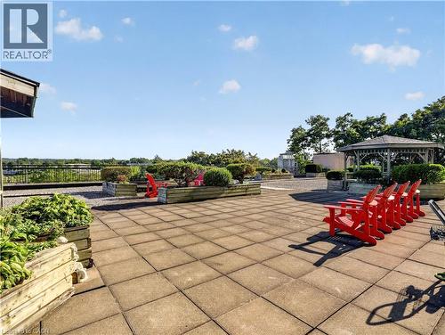 Expansive rooftop patio with paver flooring, multiple raised planters, and a decorative gazebo - 7 Gale Crescent Unit# 1107, St. Catharines, ON 