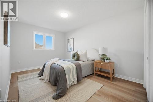 Light-toned wood-finish flooring with crisp white walls - 98 Bloom Crescent, Stoney Creek, ON 