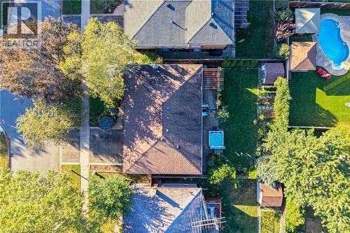 Backyard with a hot tub, turf lawn, and a pergola - 1060 Dowland Crescent, Burlington, ON 