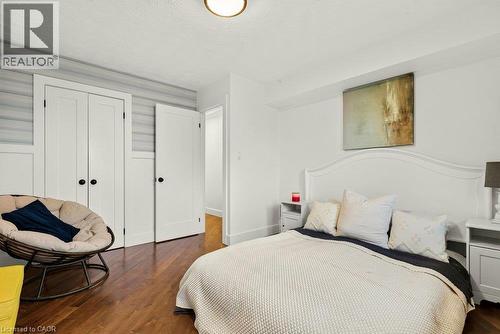 Hardwood flooring, painted white walls, recessed ceiling lighting, and built-in closet with panel doors - 9 Midway Street, Hamilton, ON 