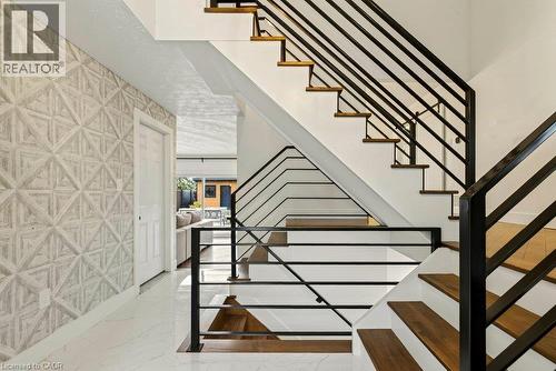Contemporary staircase with dark metal railings and wood-finish treads - 9 Midway Street, Hamilton, ON 