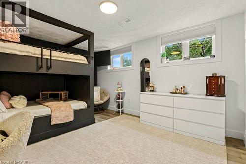 Built-in bunk beds with dark finish, recessed lighting, light-toned carpet flooring, light wood-finish flooring, and multiple windows with natural light - 9 Midway Street, Hamilton, ON 