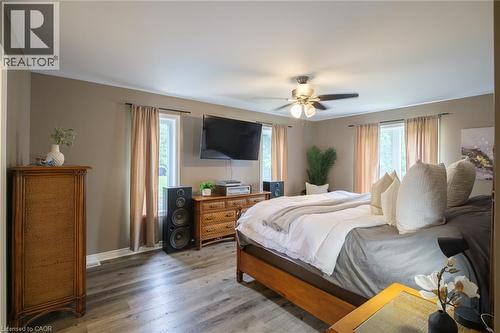 Wood-finish flooring, multiple windows providing natural illumination, and a ceiling fan with integrated lighting - 78 Oak Street, Simcoe, ON 