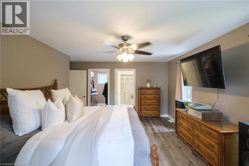 Wood-finish flooring throughout, ceiling fan with integrated lighting, and neutral wall tones - 78 Oak Street, Simcoe, ON 