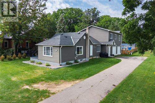 Gray siding exterior with white trim, multiple windows, and a paved driveway - 78 Oak Street, Simcoe, ON 