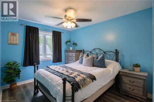 Wood-finish flooring, white trim, and a ceiling fan with integrated lighting - 78 Oak Street, Simcoe, ON 