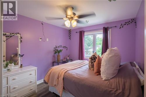 Recessed window with white trim, ceiling fan with light fixture, wood-finish flooring - 78 Oak Street, Simcoe, ON 
