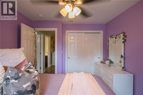 Ceiling fan with integrated lighting, white interior doors, and sliding closet doors - 78 Oak Street, Simcoe, ON 