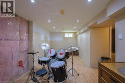 Recessed lighting throughout, wood-finish flooring, and exposed insulation - 