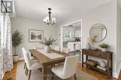 Dining room is virtually staged. - 