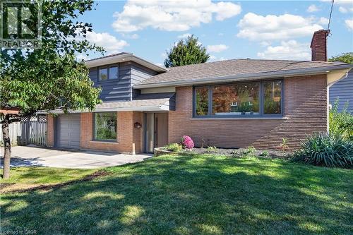 Brick and siding exterior with a shingled roof - 3028 Eva Drive, Burlington, ON 