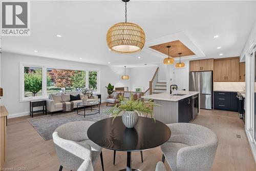Open-concept living space with light wood-finish flooring - 3028 Eva Drive, Burlington, ON 