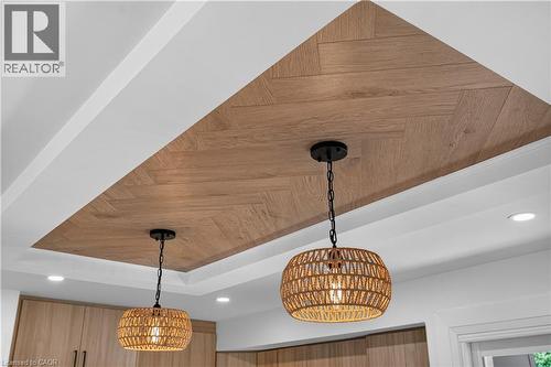 Coffered ceiling featuring a wood-finish herringbone pattern, recessed lighting, and two pendant light fixtures - 3028 Eva Drive, Burlington, ON 