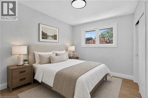 Wood-finish flooring, white trim, recessed lighting, and a window with white casing - 3028 Eva Drive, Burlington, ON 