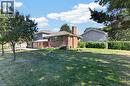 Brick and siding exterior with multiple windows, an attached chimney, and a front entry - 3028 Eva Drive, Burlington, ON 