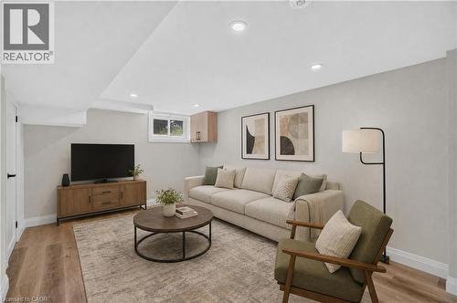 Recessed ceiling lighting, wood-finish flooring, light-toned wall finishes, and a single pane window - 3028 Eva Drive, Burlington, ON 