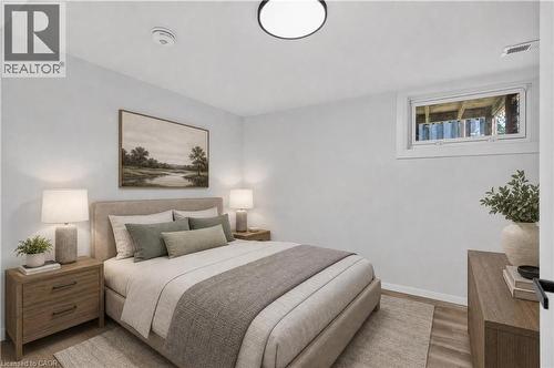 Recessed window with white trim, wood-finish flooring, and a flush-mount ceiling light - 3028 Eva Drive, Burlington, ON 
