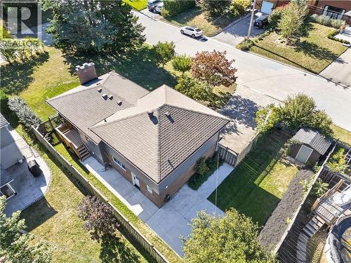 Paved driveway and walkway, fenced yard, rear wood deck with stairs, brick exterior, and a utility shed - 3028 Eva Drive, Burlington, ON 