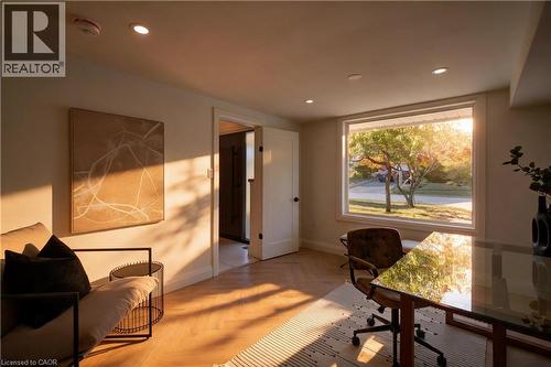 Recessed ceiling lighting, wood-finish herringbone flooring, large picture window, and solid core doors - 3028 Eva Drive, Burlington, ON 