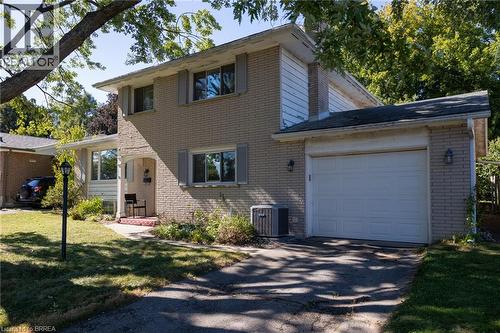 Brick exterior with white siding accents and a single-car garage - 52 Brier Park Road, Brantford, ON 